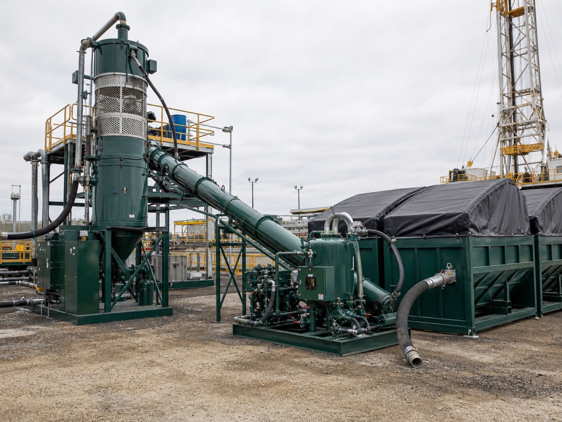 Vertical drilling cuttings dryer with access platform and sealed conveyors